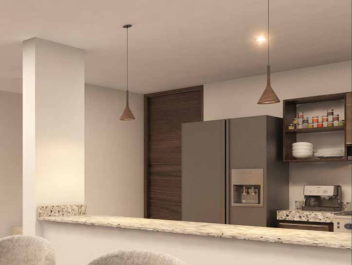 Cocina equipada de una residencia Adara: carpintería, campana y barra de mármol